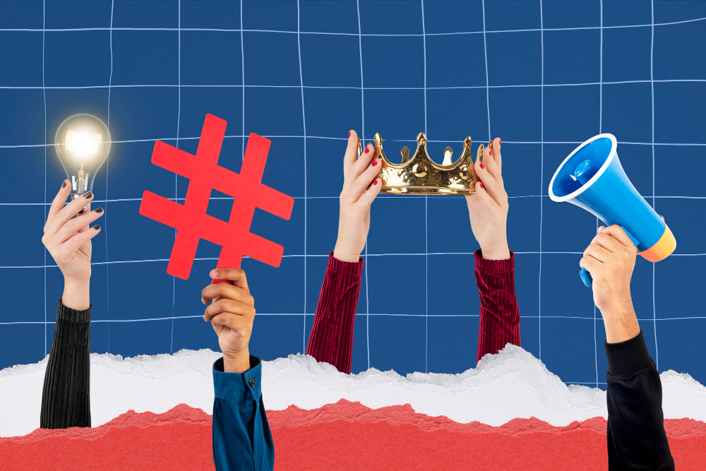 Lit bulb, red hash, golden crown and blue megaphone being held by hands, above a white foam sky.